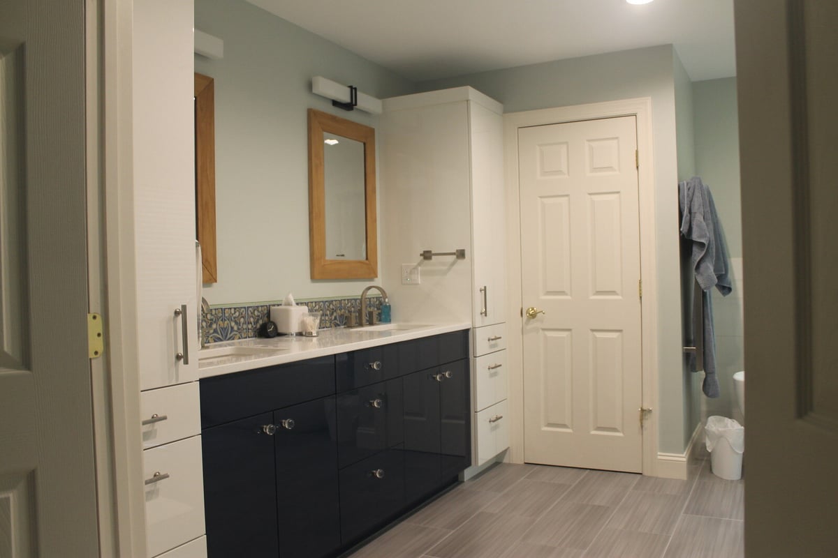 Stylish bathroom remodel with a double vanity and sleek tile flooring by Villa Builders in Annapolis, MD